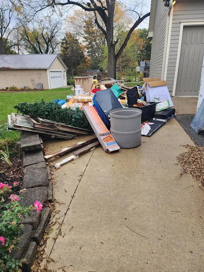 Dumpster being loaded with debris for Roofing Dumpster Rental in Potter